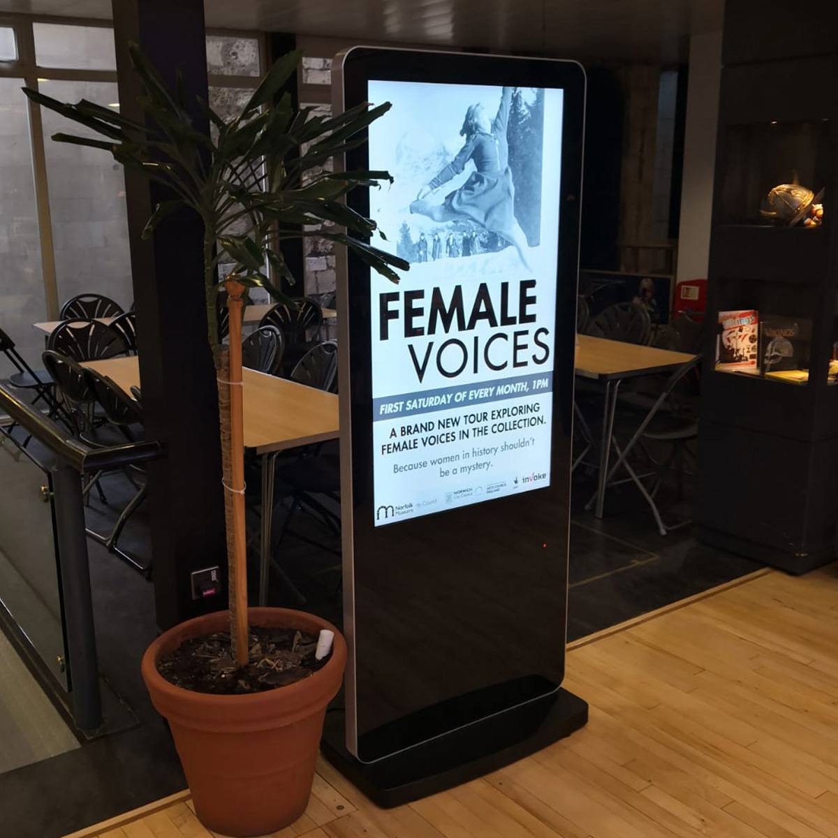 Norfolk museum free standing sign promoting monthly event showcasing female voices throughout history