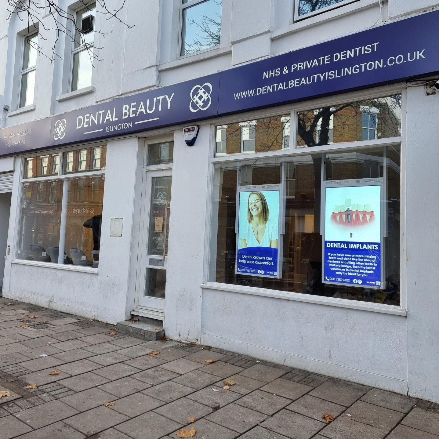 dental beauty islington signs in shop window