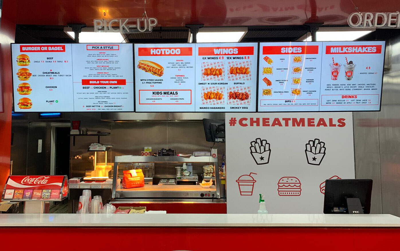 cheatmeals fast food restaurant digital menu boards above the counter