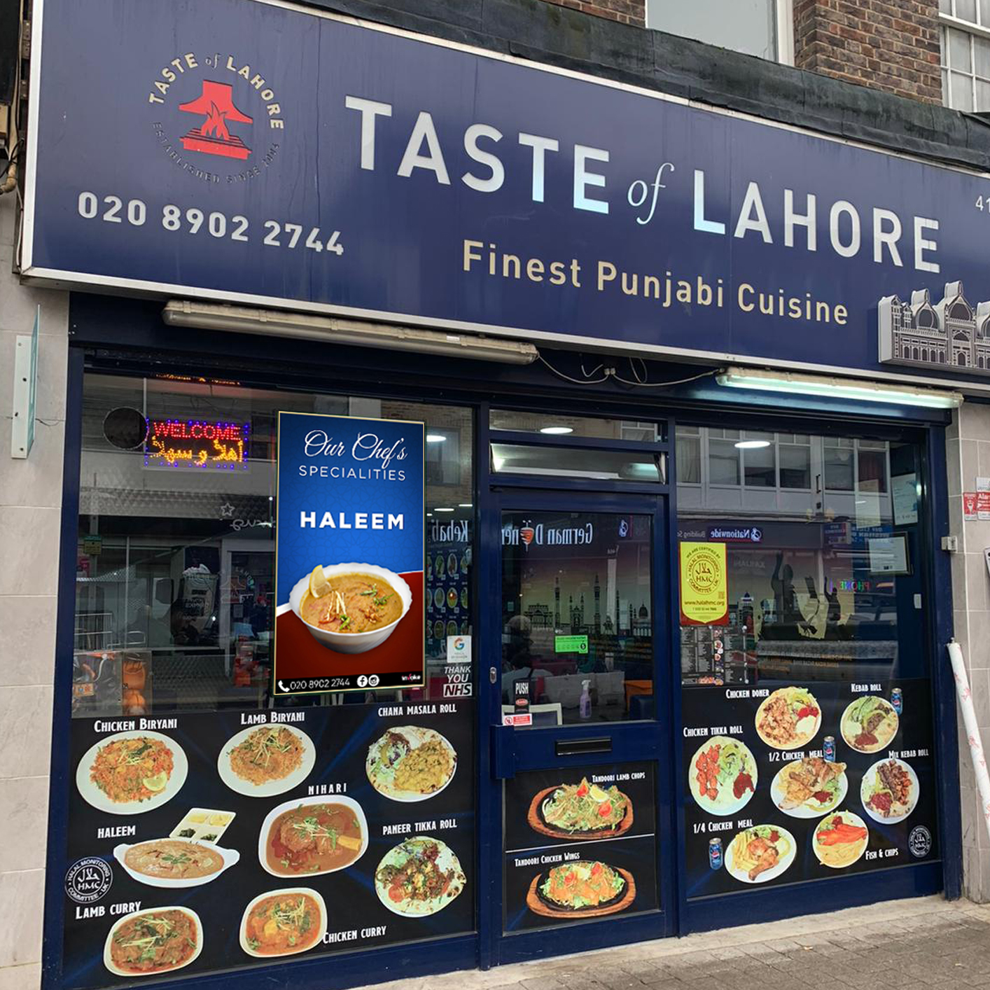 taste of lahore punjabi takeaway using a shop window screen to advertise their chef specialties