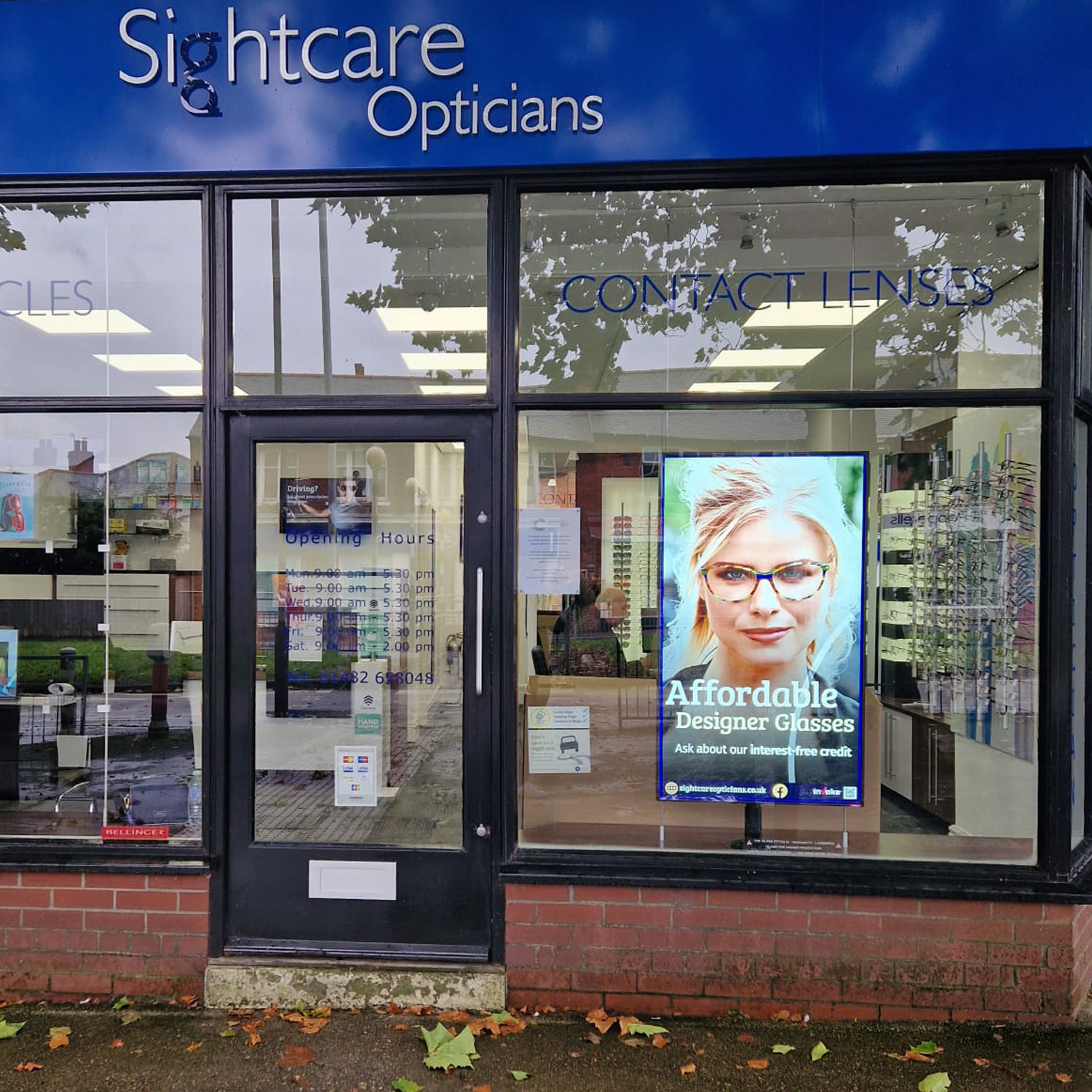 sightcare opticians using a shop window screen to advertise designer glasses and free consultations