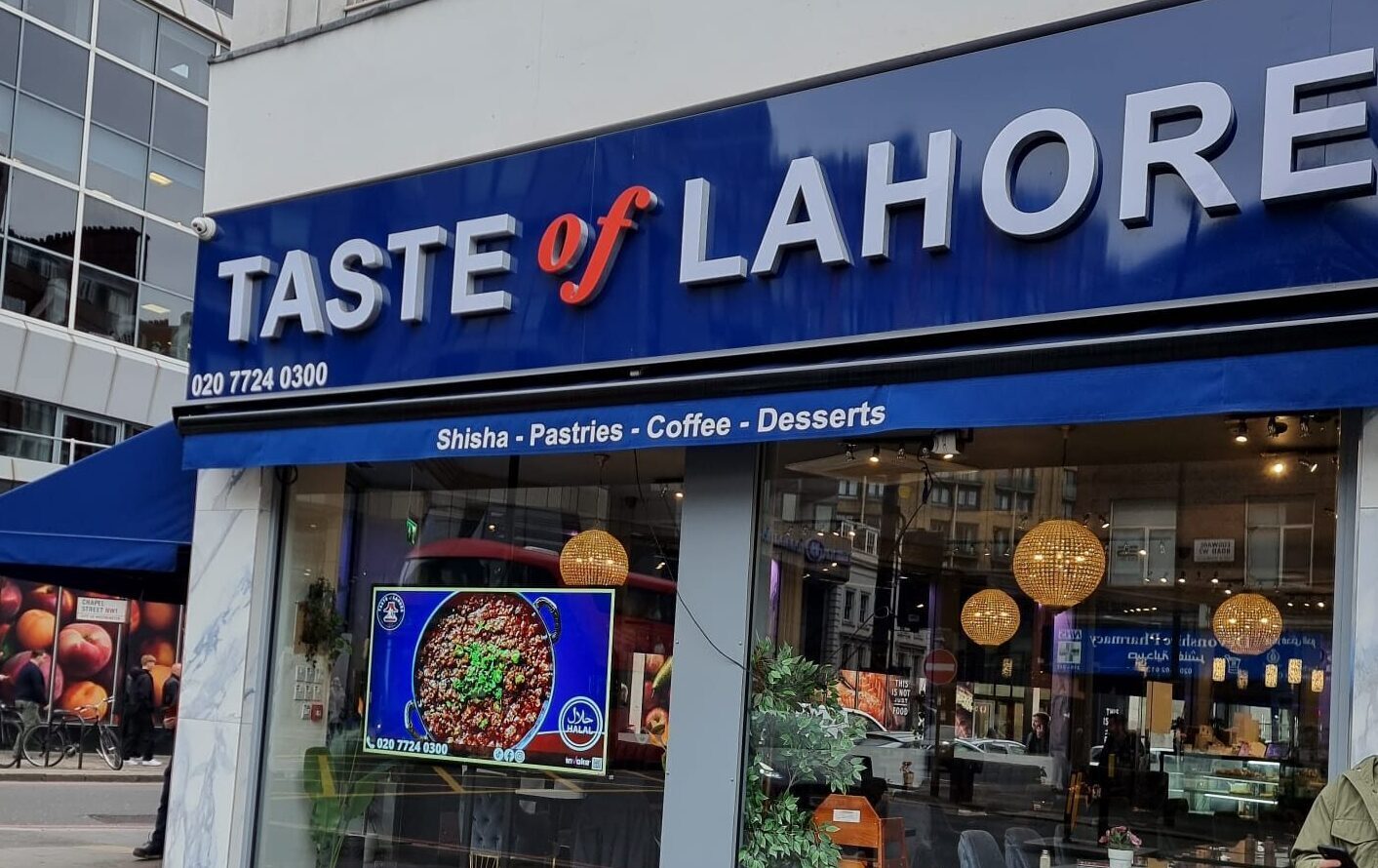 taste of lahore punjabi takeaway using a shop window screen to advertise their chef specialties